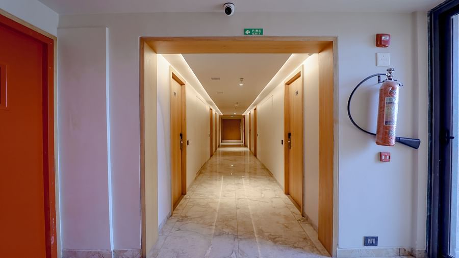 An image of a corridor leading to several rooms at Pride Resort Ambaji